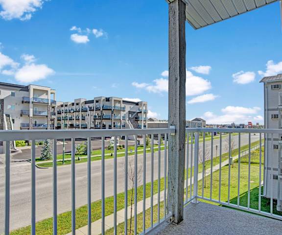 A wood, steel, and concrete balcony with a gorgeous view of the neighborhood at Windsor Terrace Apartment Homes. 