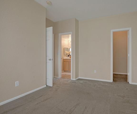 An empty bedroom with an ensuite bathroom at Camelback Pointe.