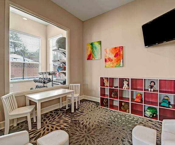 The playroom with tables and chairs and a playroom at Elements at Briargate. 