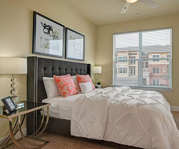 A bedroom with a queen-size bed, window, and nightstands at Elements at Briargate 