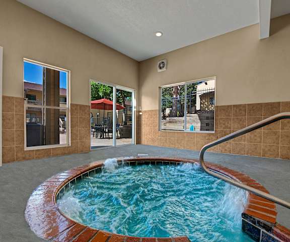 The turquoise indoor jacuzzi with a door and windows to the outdoor patio at Grand View. 