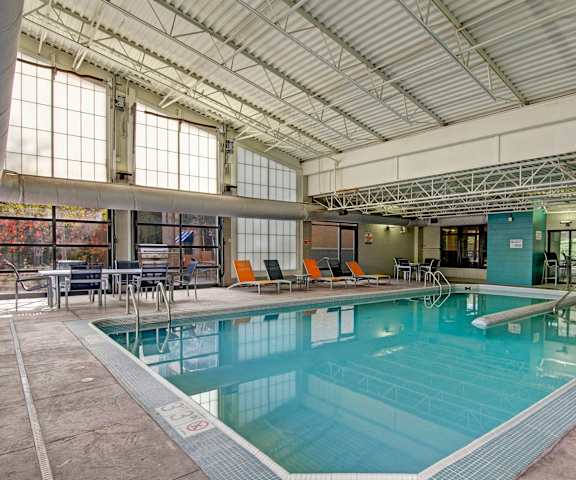 The indoor pool with tables and chairs at Marbella on Dean Apartments. 