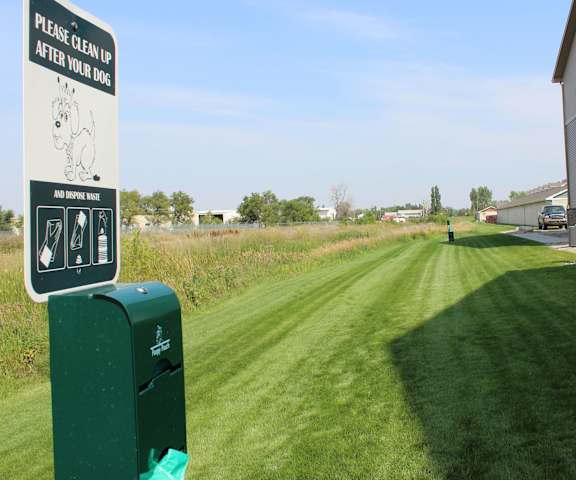 The exterior and green space at Dakota Commons Apartments. 