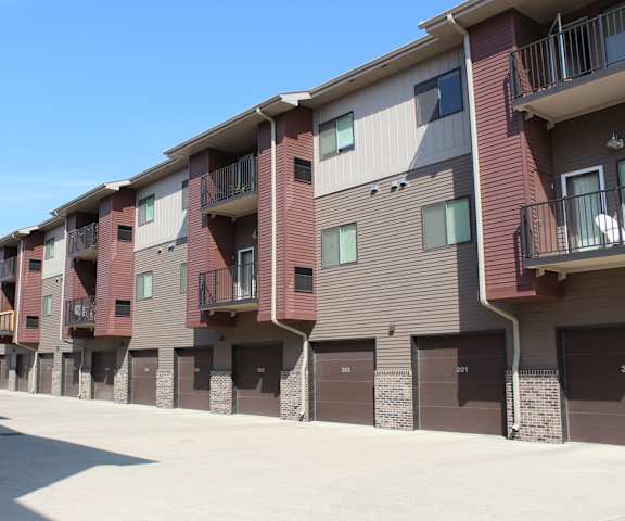 The exterior of the buildings and parking at Dakota Commons Apartments. 