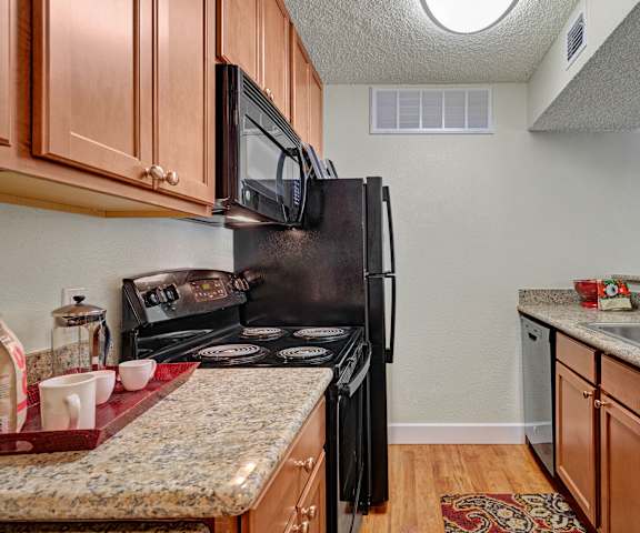 The kitchen at Acacia Park Apartment Homes with granite countertops and appliances. 