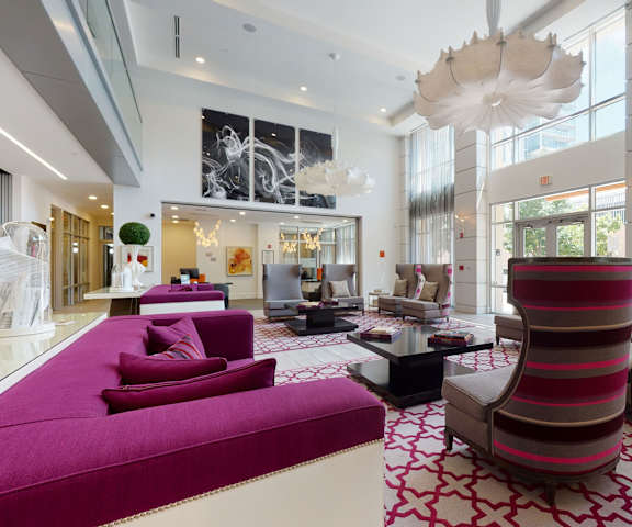 Lounge with couches and plush chairs at Arpeggio Apartments. 
