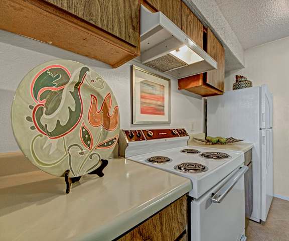 A kitchen with white appliances and counters at Cypress Pointe Apartments. 