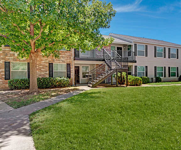 The exterior and green space at Cypress Pointe Apartments. 