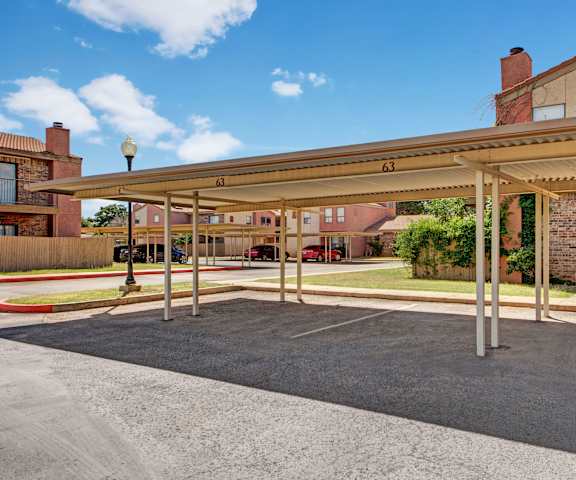 The exterior of the buildings and parking lot at Las Colinas Apartments. 