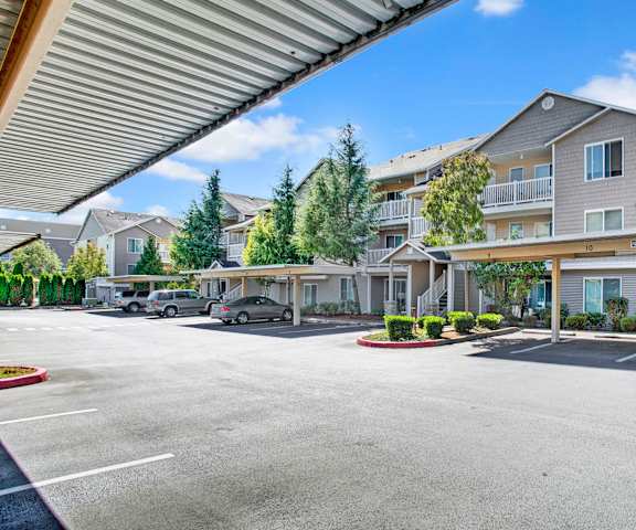 An empty parking lot in front of an apartment building at Allegro. 