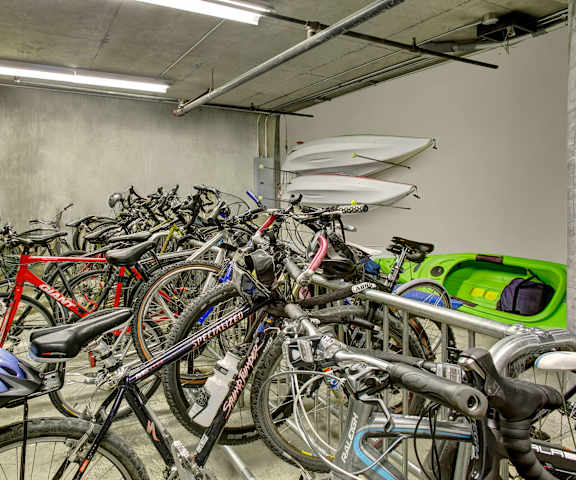 The bike storage room full of bikes with a kayak at St. James Tower Apartments. 