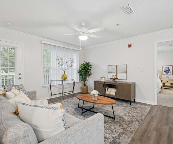 A living room with a grey couch and a coffee table.