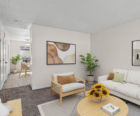 A living room with a white couch, a wooden chair, and a coffee table with a vase of sunflowers on it.
