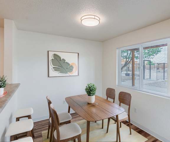 A dining room with a wooden table and chairs.