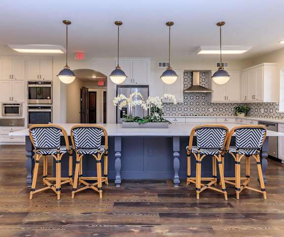 a large kitchen with a large island and chairs at Mariposa at Westchester, Grand Prairie