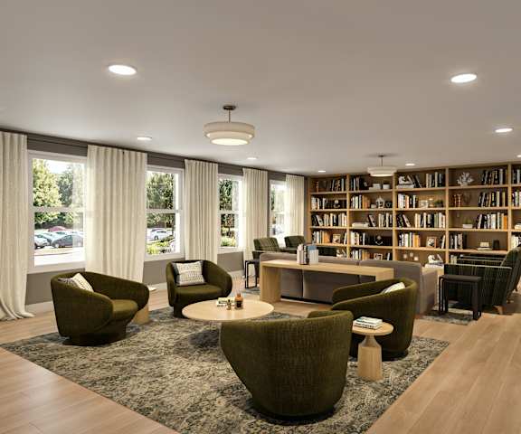 A room with a large bookshelf filled with books and a round table surrounded by chairs.