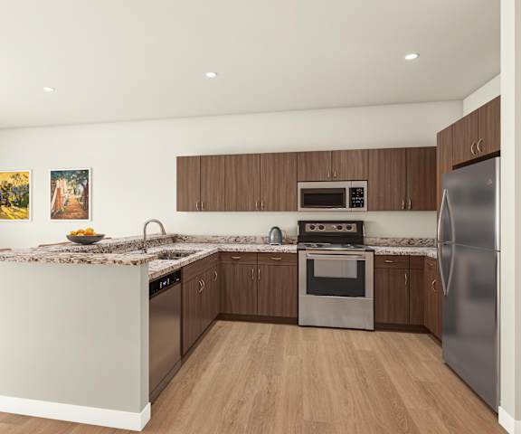 A modern kitchen with a granite countertop and stainless steel appliances.