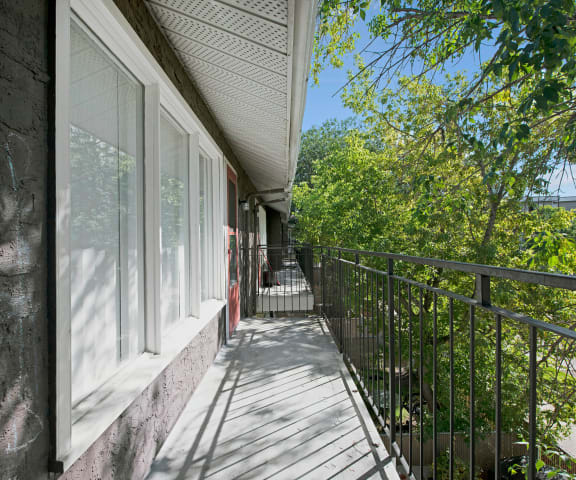 The balcony with a view of trees at Broadmoor Apartments. 