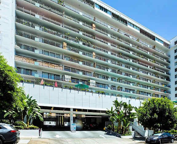 A large white building with a parking lot in front of it.at Hollywood Ardmore, Los Angeles, CA