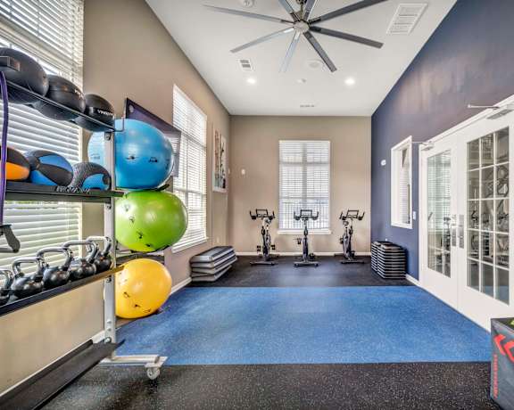 the gym with weights and cardio equipment at the flats at west end apartments