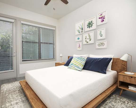 a bedroom with a large bed and a window