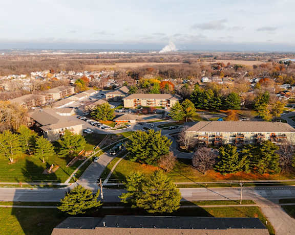 A view of a school from above with a road running through it. at Rosemont Place Apartments, Des Moines, IA, 50320