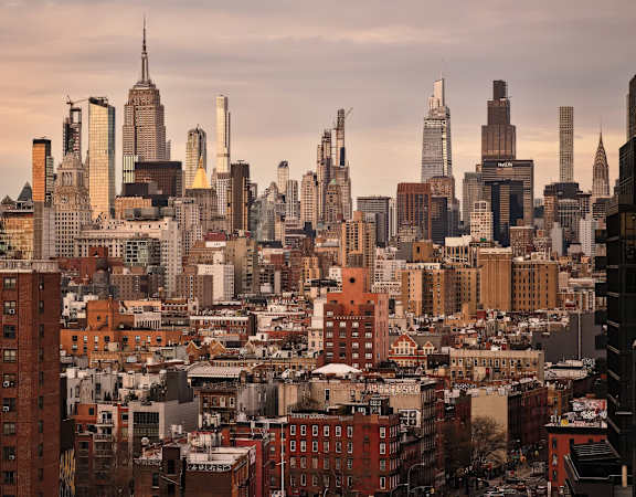 A cityscape with a mix of modern and older buildings.