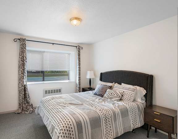 a bedroom with a bed and a window