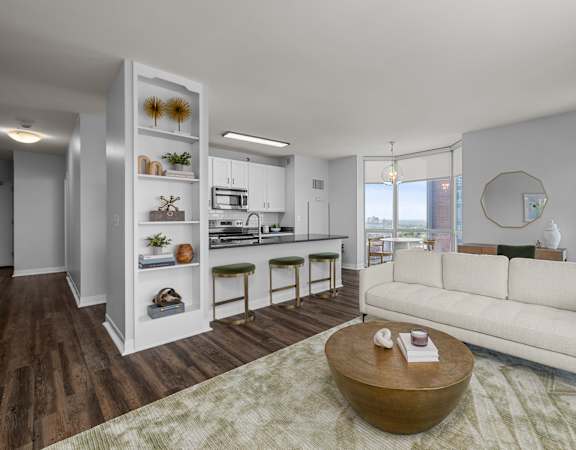 A modern living room with a white sofa and a coffee table at Clayton on the Park Apartments, Clayton, Missouri