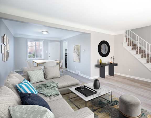A living room with a grey couch and a coffee table.
