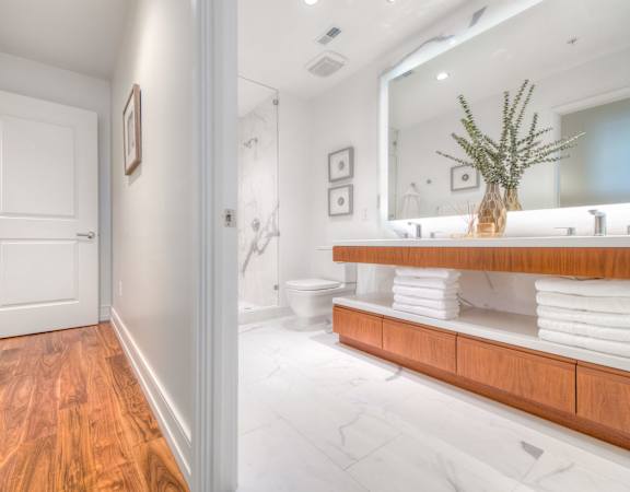 a bathroom with a large mirror and a counter with towels