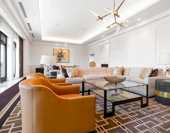 a living room with couches and a glass coffee table