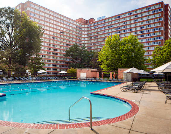 a swimming pool at a hotel with a large building