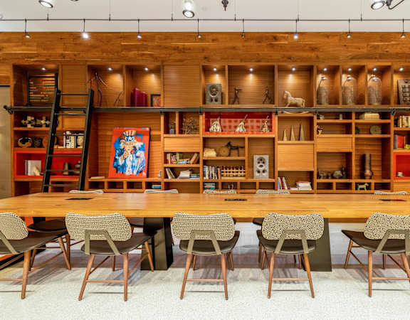 a dining room with a long wooden table and chairs at The Bartlett in Arlington, VA 22202