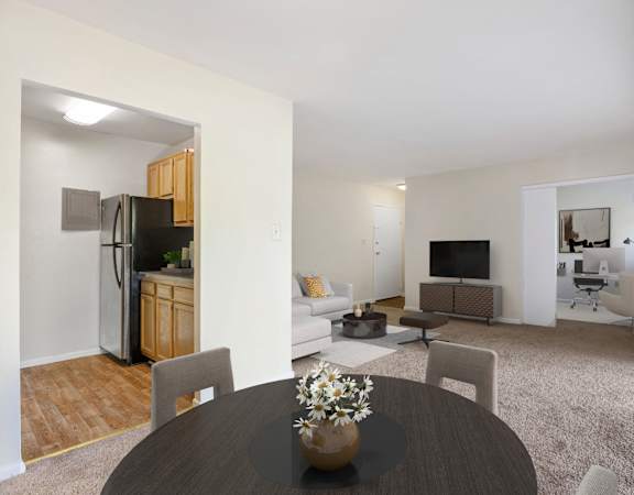 A modern living room with a dining table and chairs.