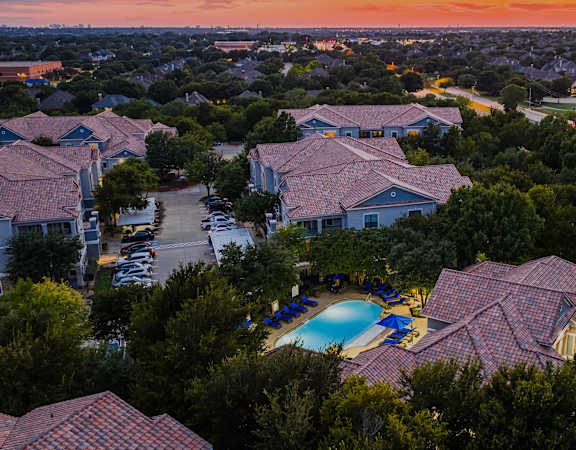 Aerial photo of DeLayne at Twin Creeks with pool at dusk