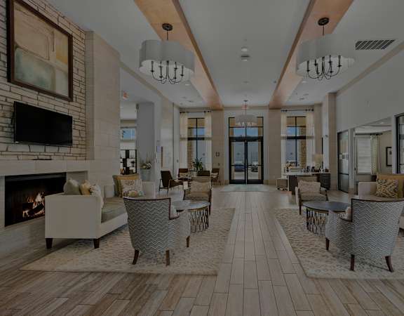 Resident clubhouse social area with fireplace - Nona Park Village Apartments