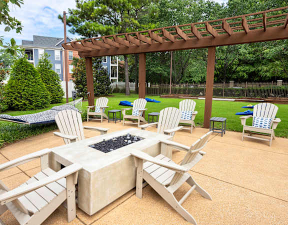 Fire pit lounge with ample seating and hammock - The Estates at River Pointe