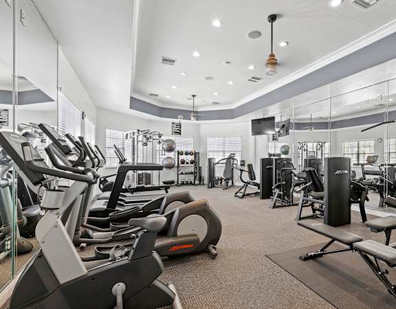 Resident fitness center with cardio and weight equipment - Delano at Cypress Creek