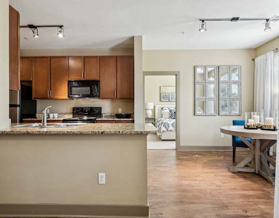 Custom 42-inch chestnut cabinetry - Acadia at Cornerstar Apartments