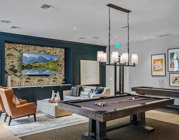 Game room with billiards table and shuffleboard - The Remy Apartments