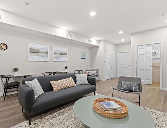 a living room with a couch and a table at Switchback on Platte Apartments, Littleton, CO 80120