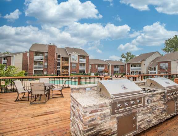 the preserve at ballantyne commons outdoor deck with a grill and table with chairs