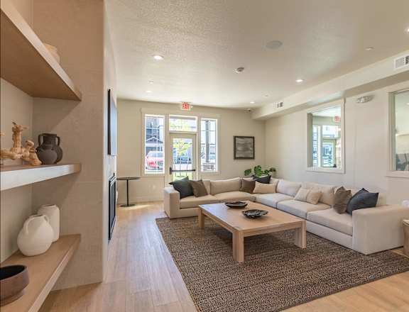 A living room with a couch, coffee table, and a television at Cascade Place Apartment Homes, Molalla, OR, 97038