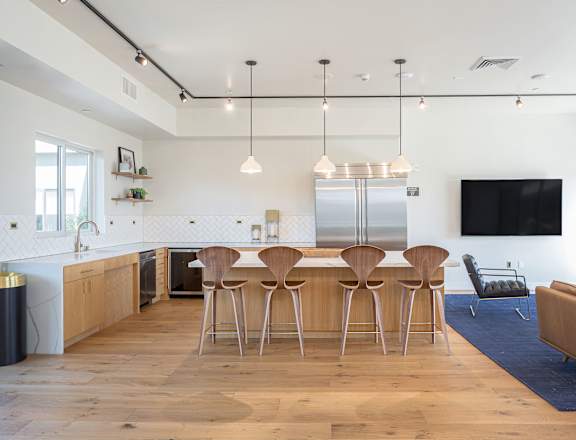A view of the kitchen and living room from the dining area at Mariposa on 3rd, Los Angeles, CA 90004