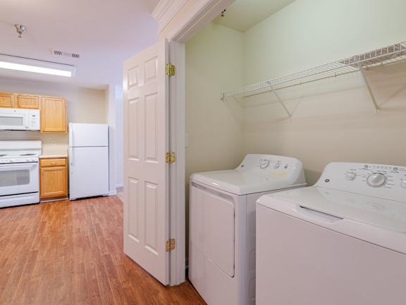 A laundry room with a washer and dryer.at The Gardens of Stafford, Stafford