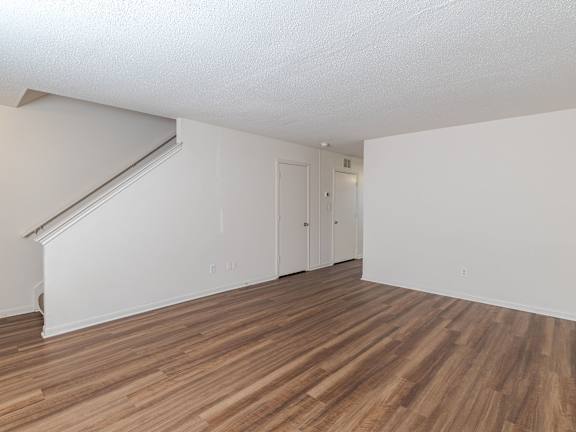 A room with wooden flooring and white walls.at The Village at England Run, Fredericksburg, VA