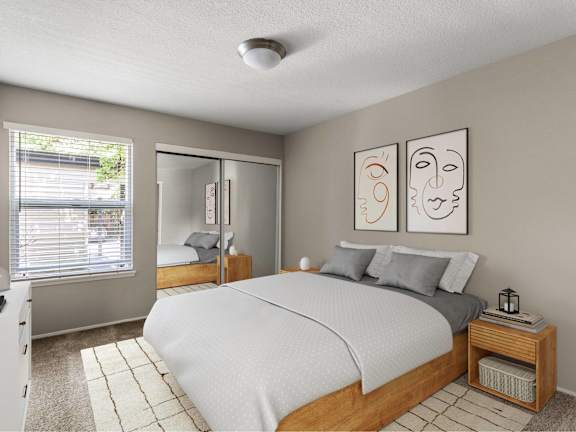 A bedroom with a bed, nightstand, and two framed pictures on the wall.