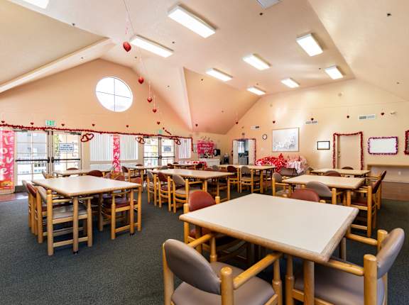 A classroom with tables and chairs and a window. at Whispering Fountains Diamond Bar, Diamond Bar, 91765