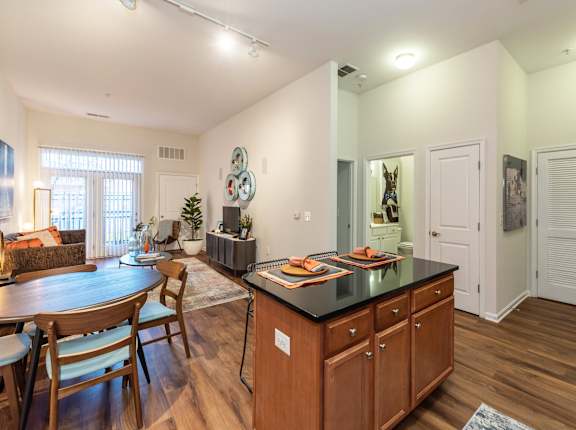 A kitchen with wooden cabinets and a black countertop.